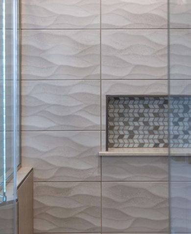 Textured shower tiles in the primary bathroom at south Bethany Beach created by Nally Homes.