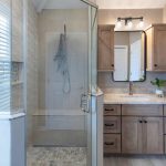 Nally Homes newly renovated bathroom oasis in Bethany Beach including a walk-in shower, and a beautifully designed sink with drawers.